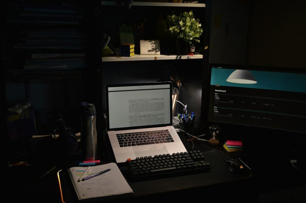 Developer workstation with laptop and monitors illustrating HTML5 browser game creation