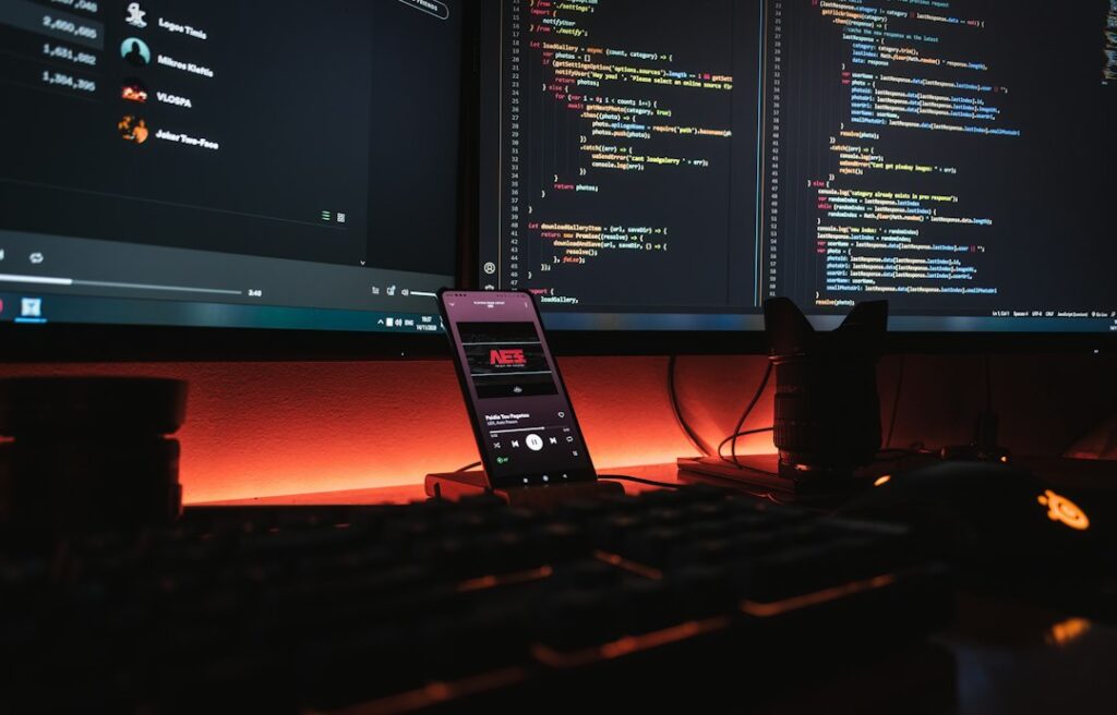 Game developer workstation with computer monitors displaying programming code